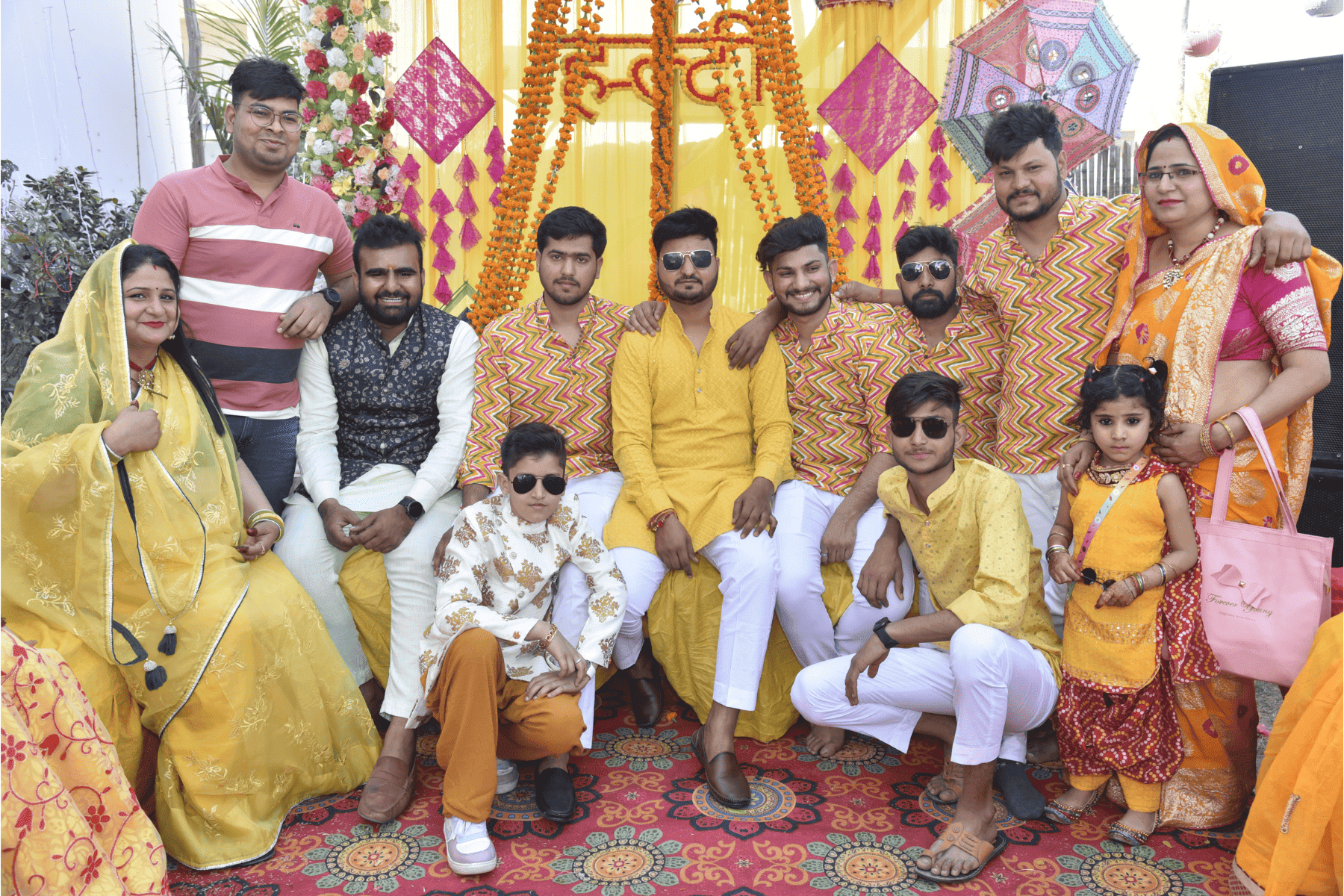 Group photo during Haldi ceremony with bride surrounded by family and friends
