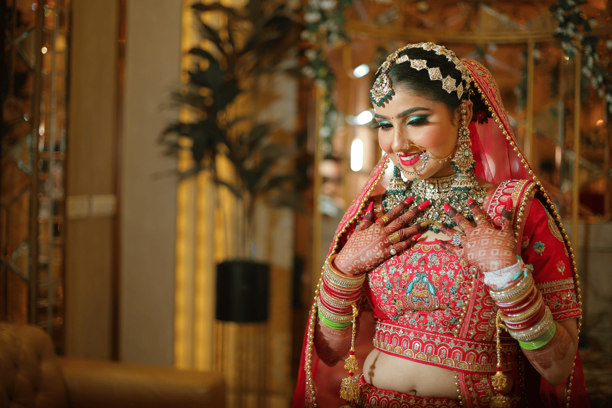 Creative bridal photoshoot – bride posing on designer table in wedding attire