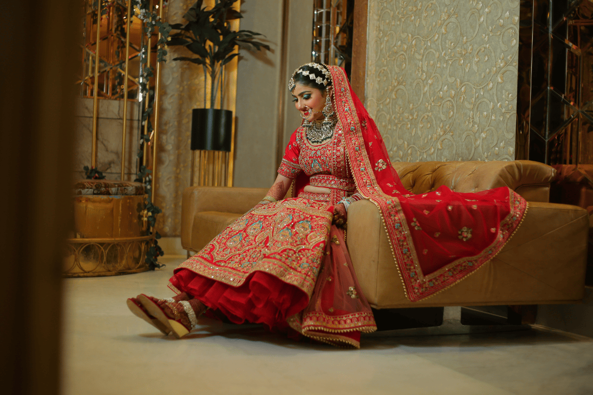  Modern bridal portrait – bride sitting confidently on wedding table