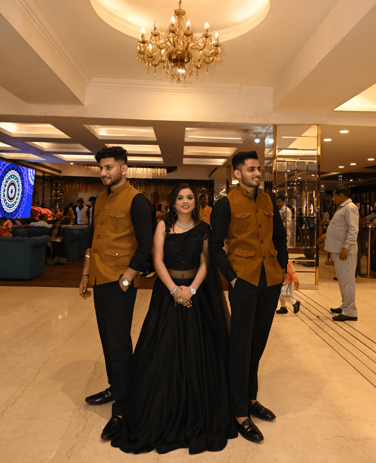 Wedding ceremony photo with sister in center and brothers standing beside her during haldi function