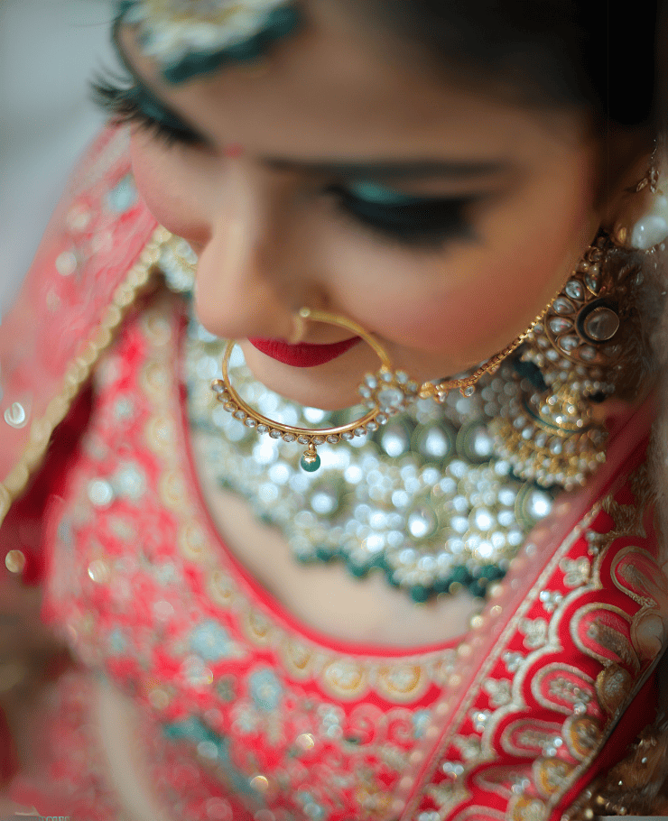 Close-up of Indian bride wearing traditional bridal nath during wedding shoot