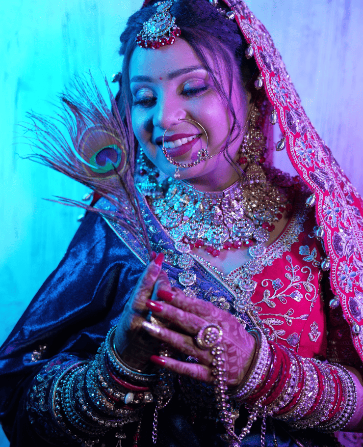 Indian bride holding mor pankh during traditional wedding photoshoot