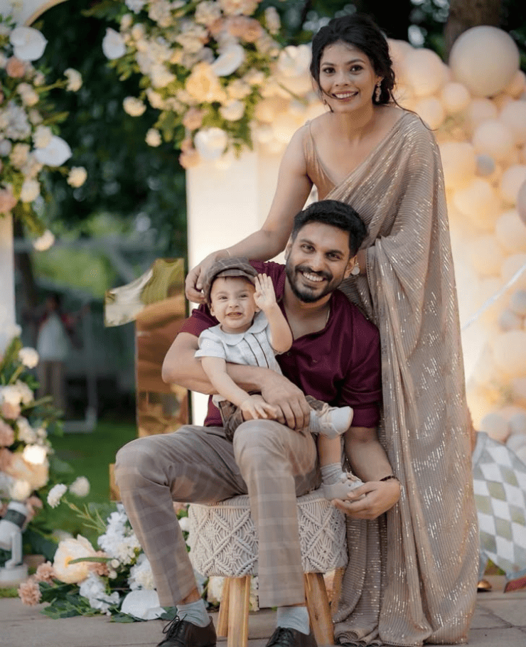 High-quality birthday photo of happy kid with parents captured by top birthday photographer in Delhi