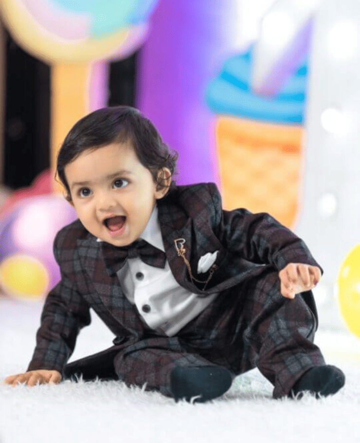 Cute baby boy smiling during birthday photoshoot by professional photographer in Delhi