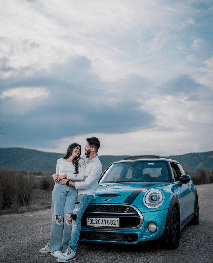 Romantic pre-wedding shoot with couple standing in front of vintage car, clicked by SK Digital Photo Studio