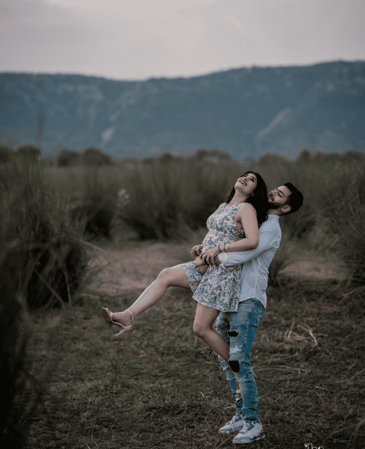 Romantic couple pose during pre-wedding shoot in Jaipur as man lifts fiancée in arms, captured by SK Digital Photo Studio